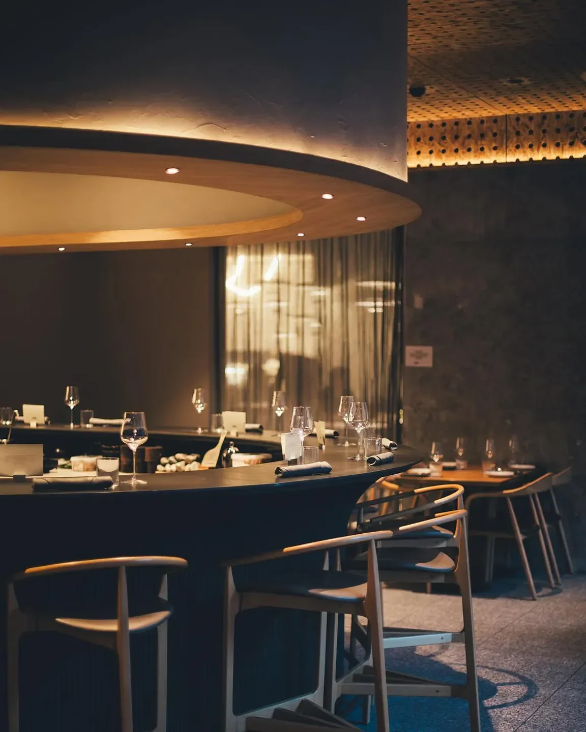 Interior of KOI Experiential restaurant in Sydney featuring bar and stylish seating.