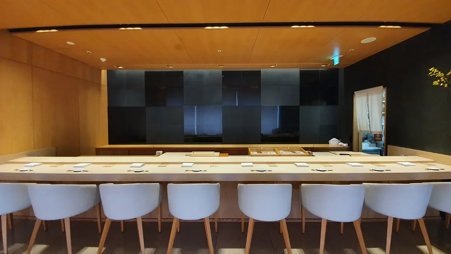 Interior view of Kojima restaurant in Seoul, showcasing the sushi bar and seating area.