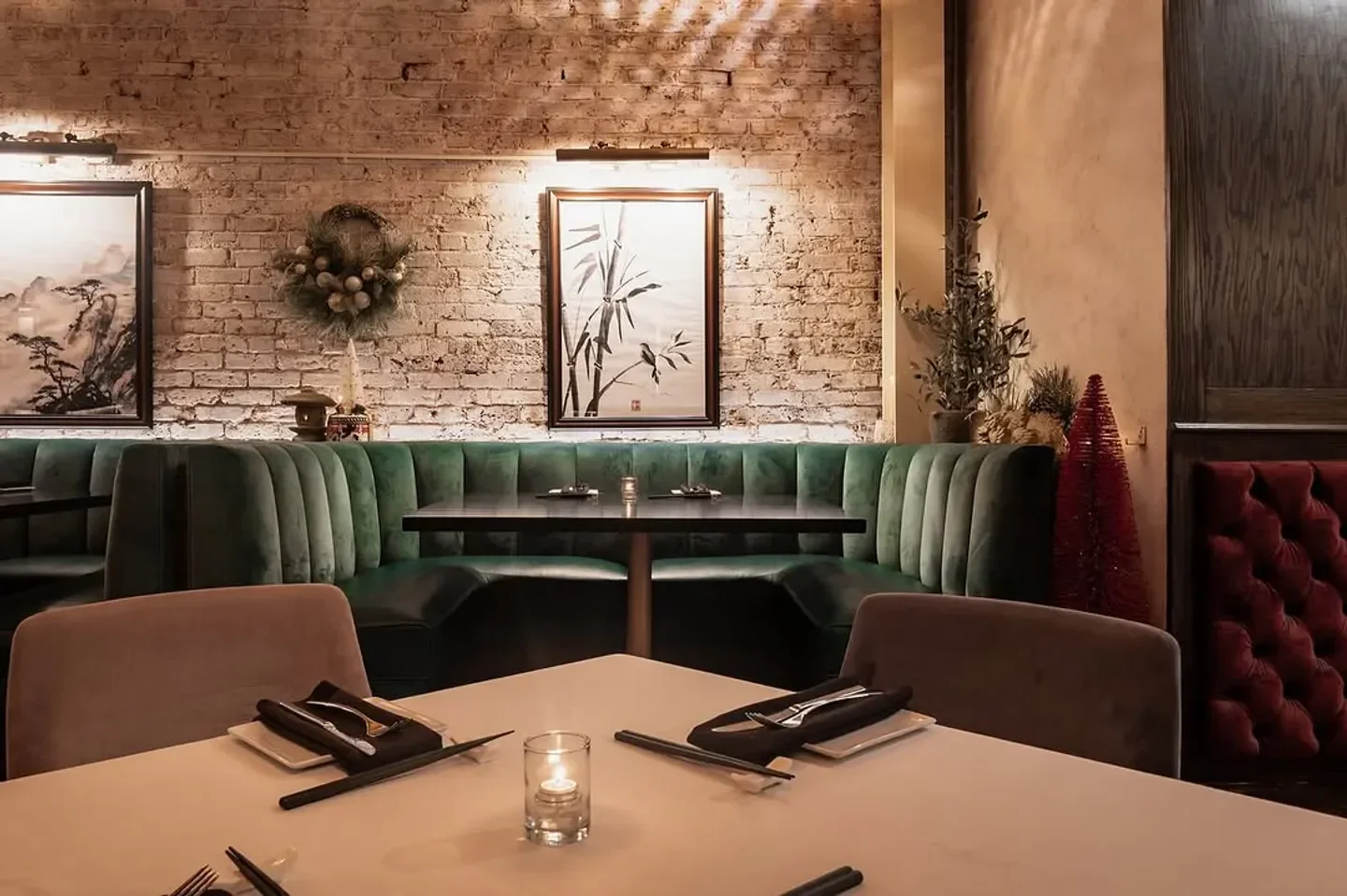 Cozy dining area at KOMO restaurant in Chicago with brick wall and elegant decor