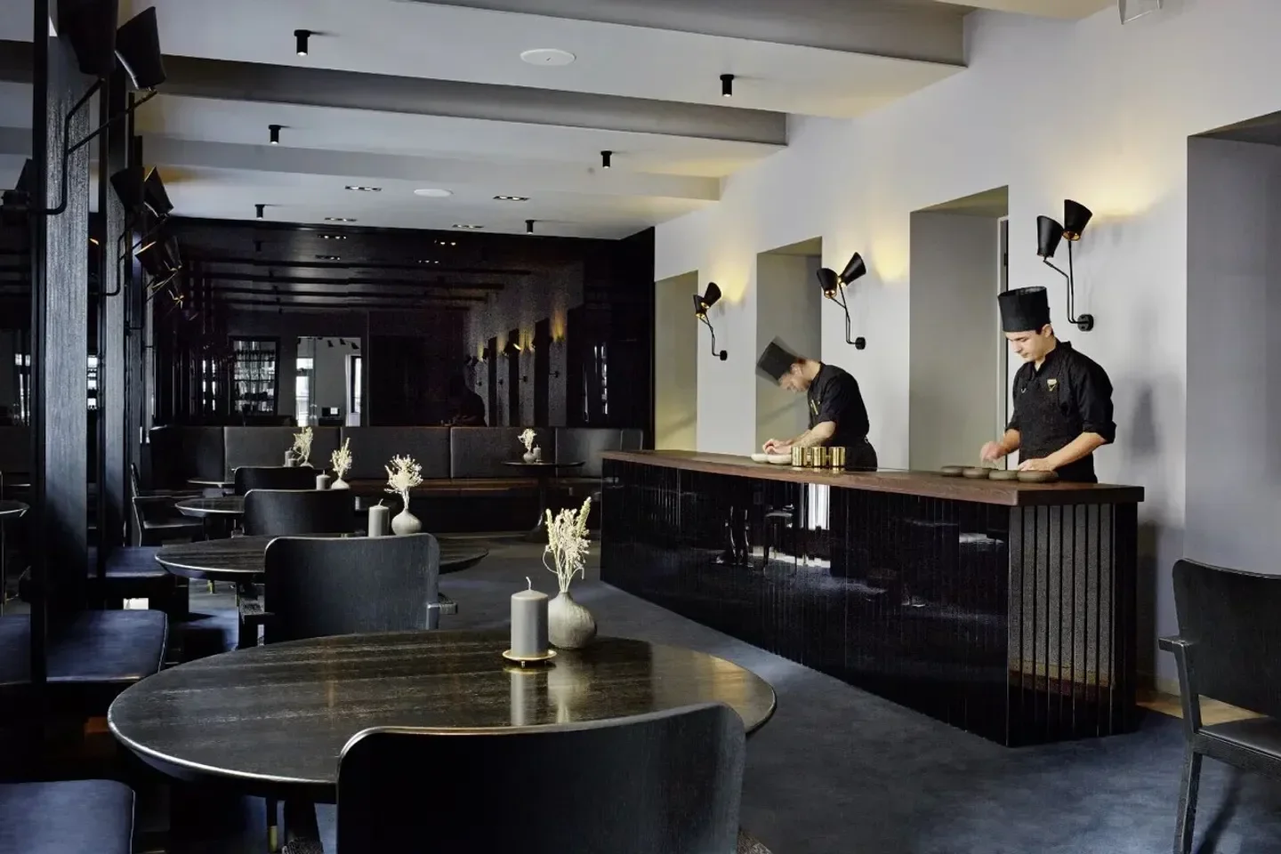 Interior of Konstantin Filippou restaurant in Vienna, featuring chefs and stylish decor.