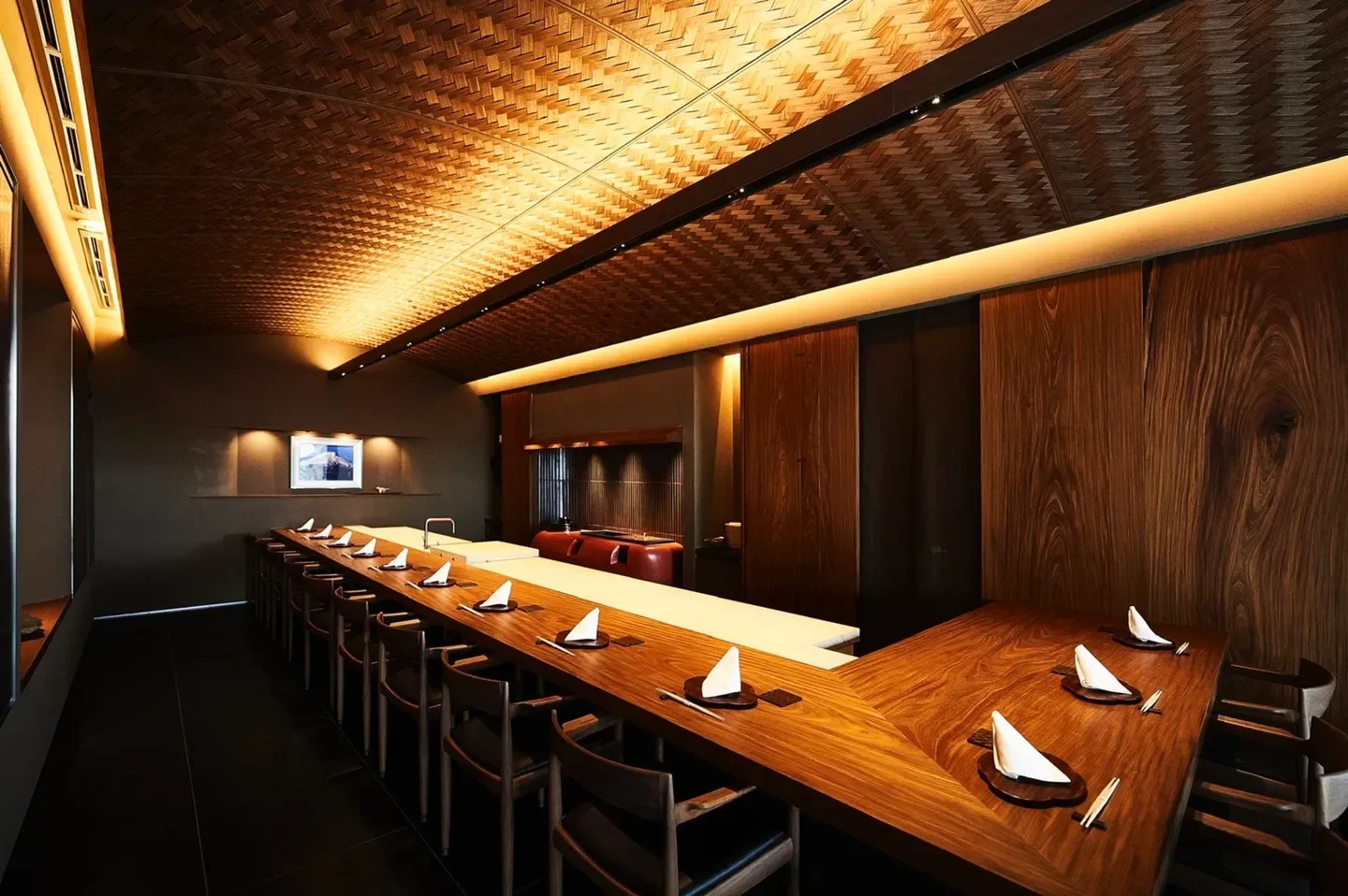 Interior view of Koryu restaurant in Osaka, featuring wood and woven ceiling design.