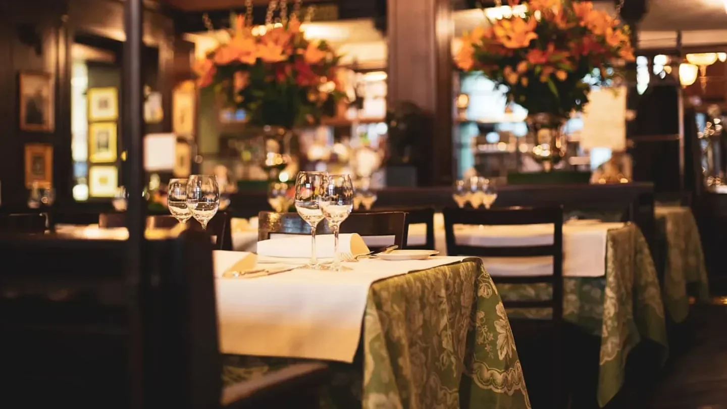 Elegant dining at Kronenhalle restaurant in Zurich with floral arrangements and table settings