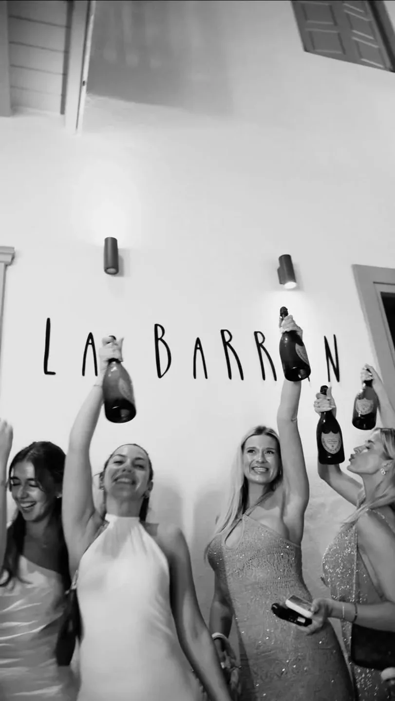 Women celebrating with champagne at La Barran nightclub in Mykonos