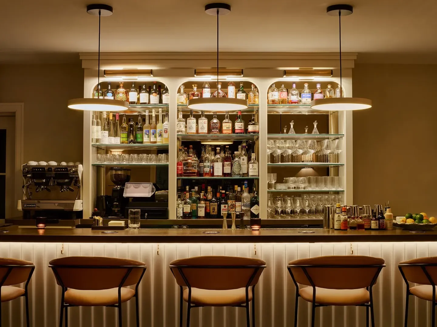 Interior bar at La Bastide by Andrea Calstier in the Hudson Valley with chairs and lights.