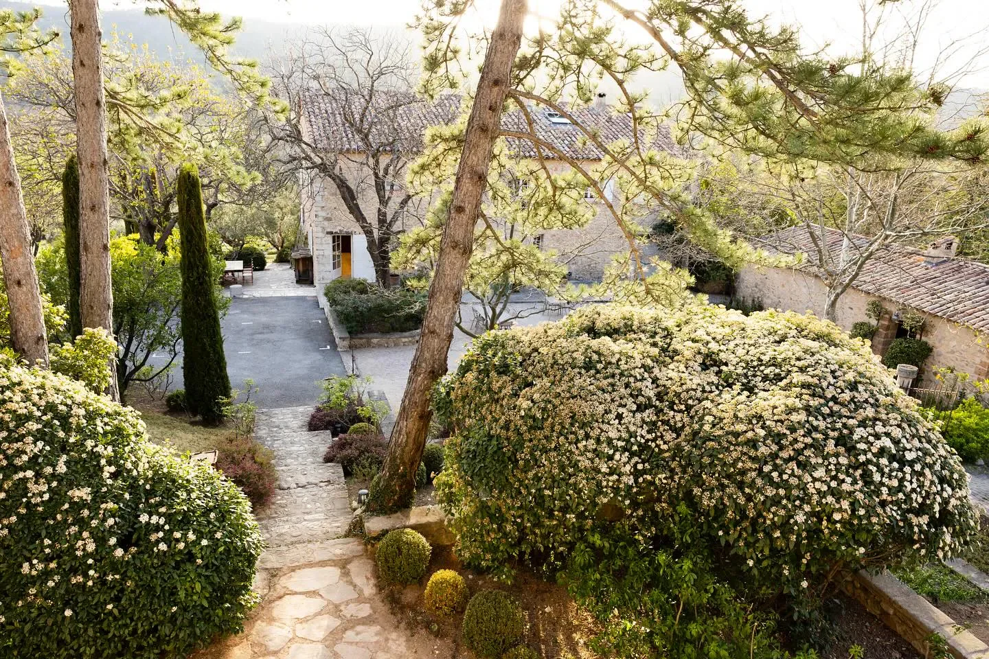 Scenic view of La Bastide de Moustiers restaurant in Provence, France with lush garden.