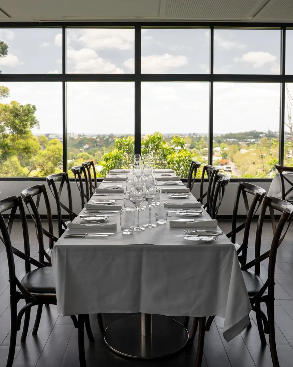 Elegant dining table at La Belle Vie restaurant in Brisbane with beautiful city view.