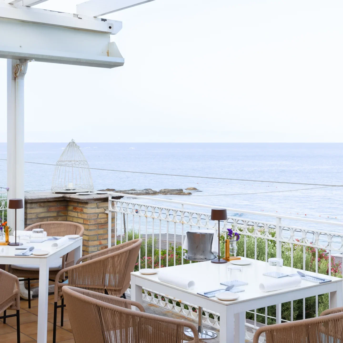 La Capinera restaurant in Sicily offers stunning sea views from its white-clothed tables and wicker chairs.