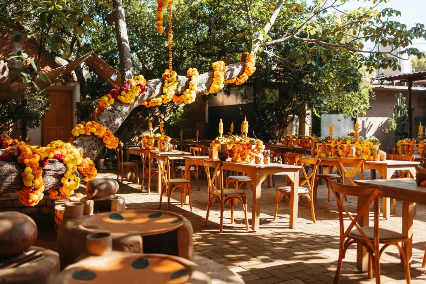 Outdoor dining at La Cocina de Humo in Oaxaca, adorned with floral decorations.