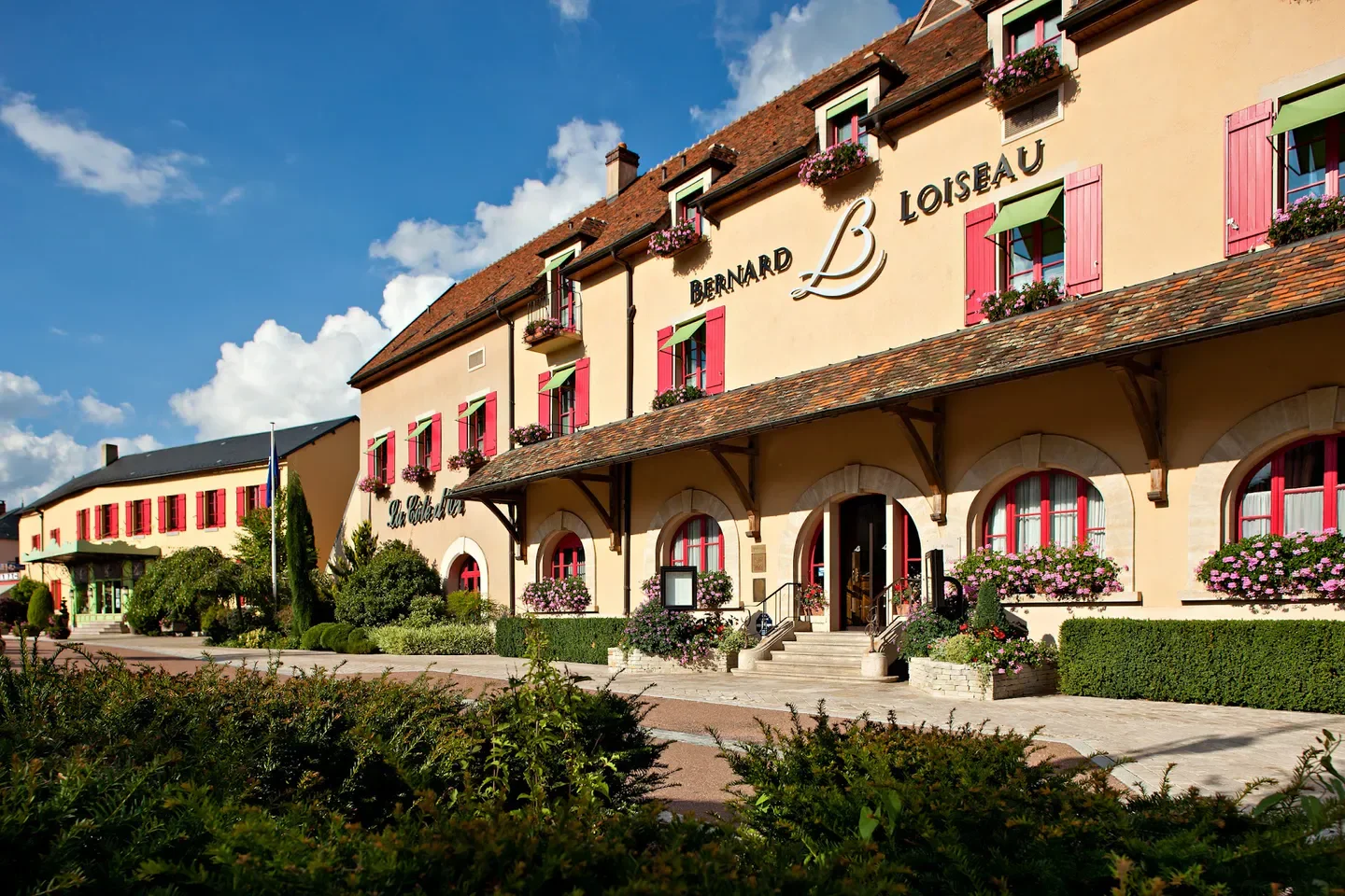 Exterior view of La Côte d'Or - Relais Bernard Loiseau in Bourgogne, France, on a sunny day
