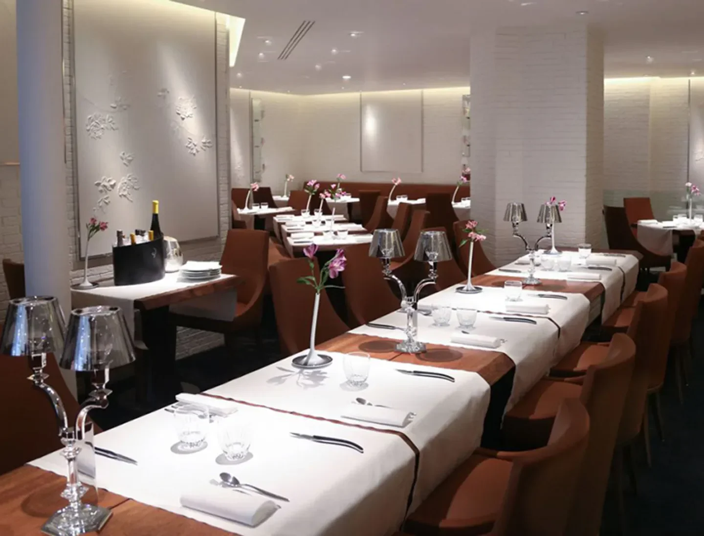Elegant dining room interior at La Dame de Pic restaurant in Paris, featuring stylish decor.