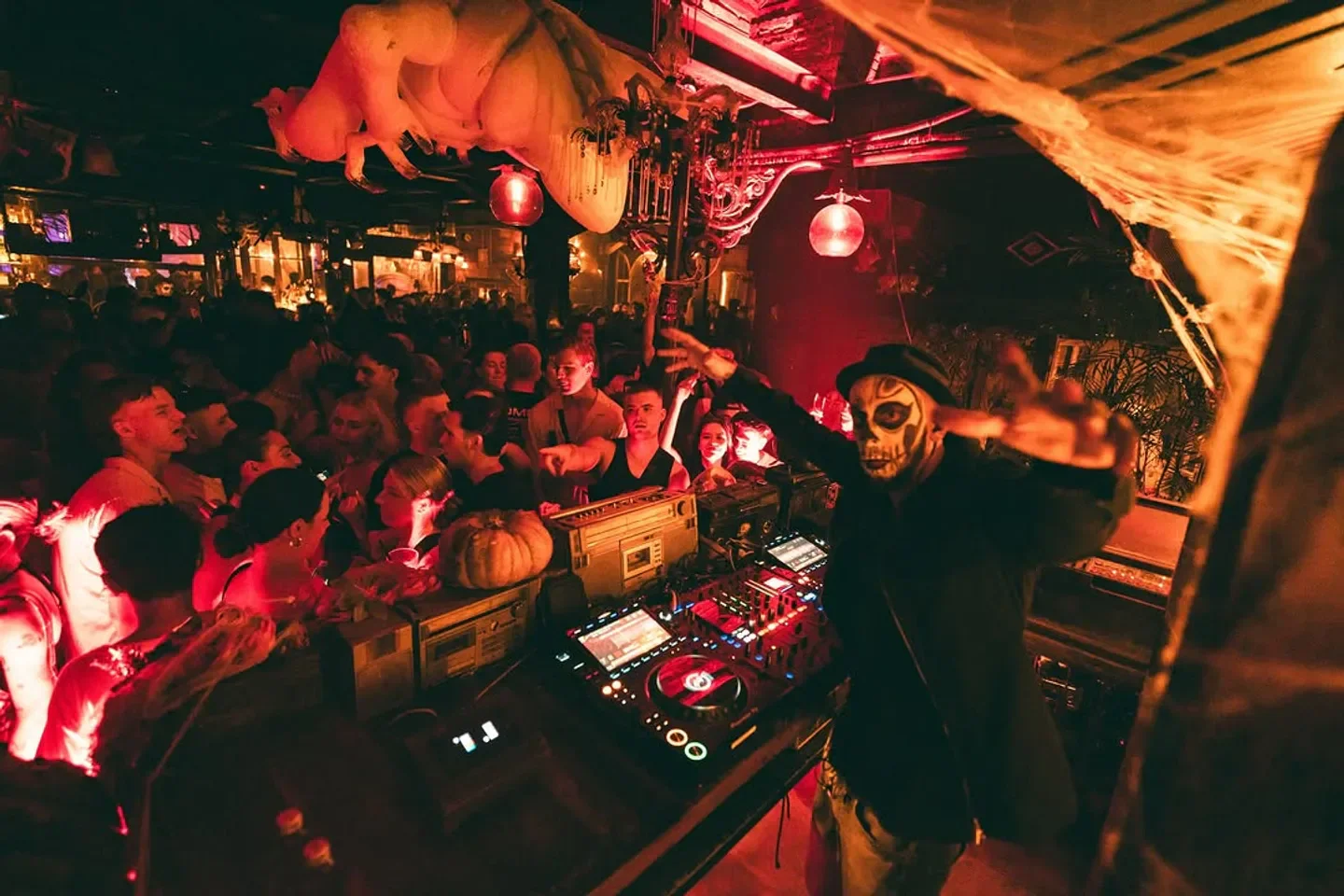 DJ at La Favela Bali nightclub, a vibrant scene with people and decorations.
