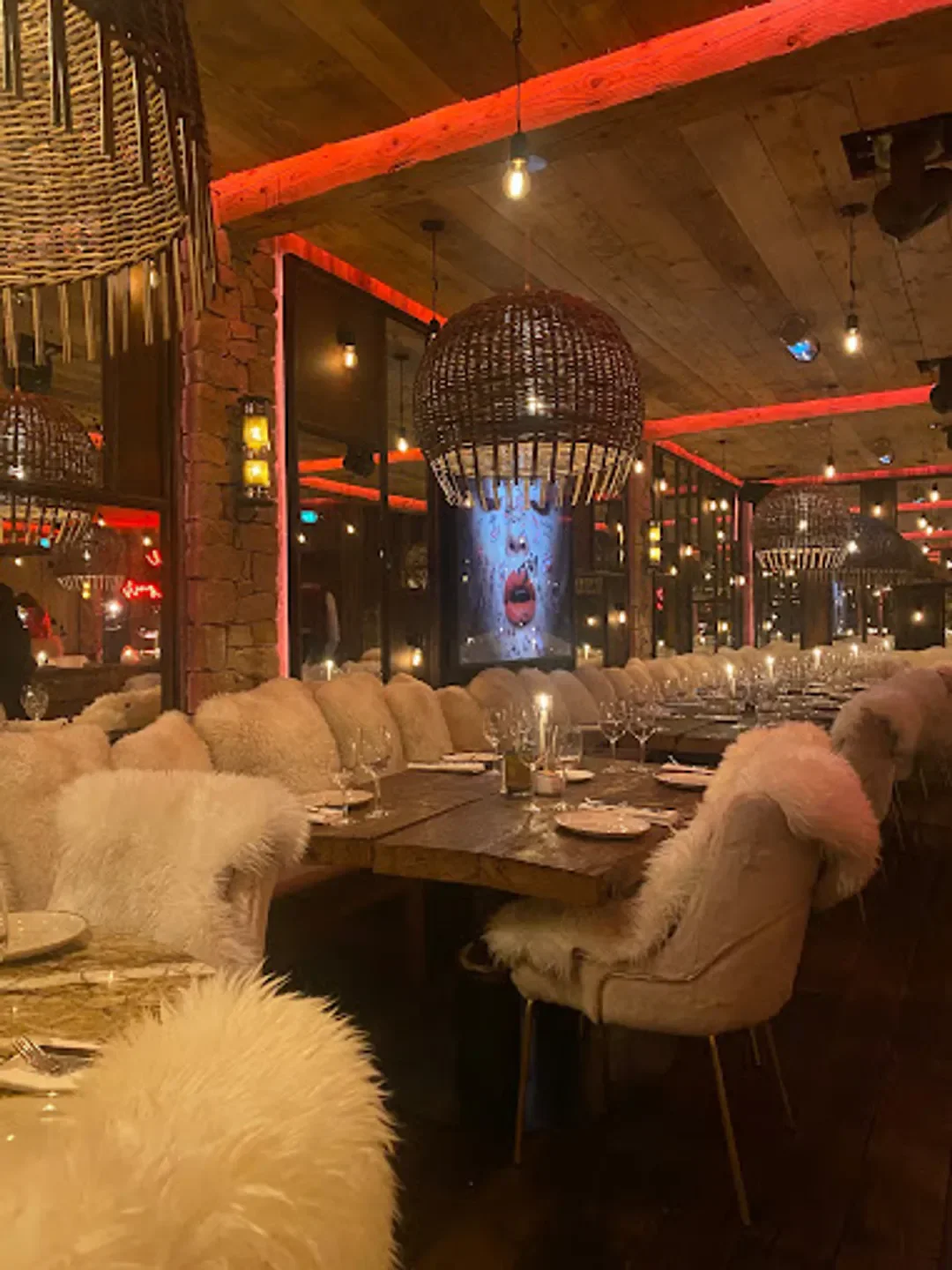 Cozy dining room at La Ferme Saint-Amour in Megeve with fur-covered chairs and rustic decor