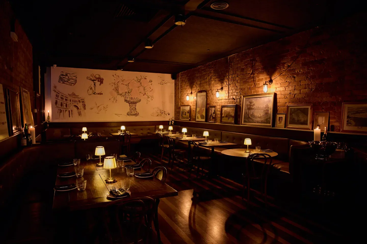 Cozy interior of La Louisiane restaurant in Adelaide, featuring brick walls and warm lighting.