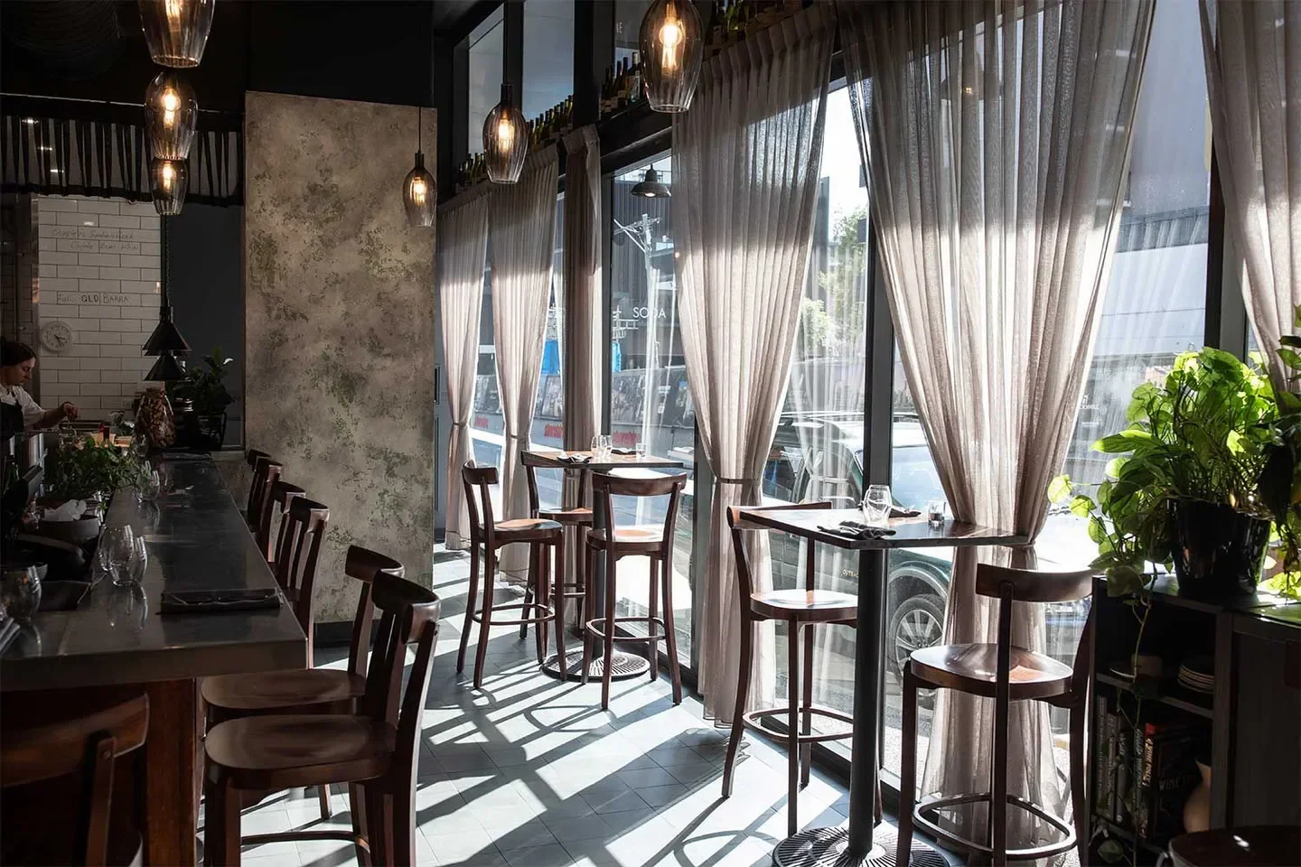 Interior of La Lune Wine Co in Brisbane, featuring dining tables with natural sunlight.