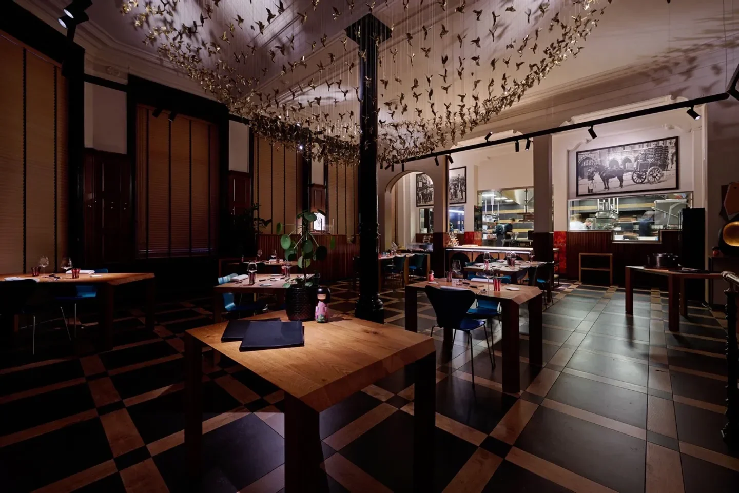 Interior of La Paix restaurant in Brussels, featuring artistic decor and elegant dining setting.