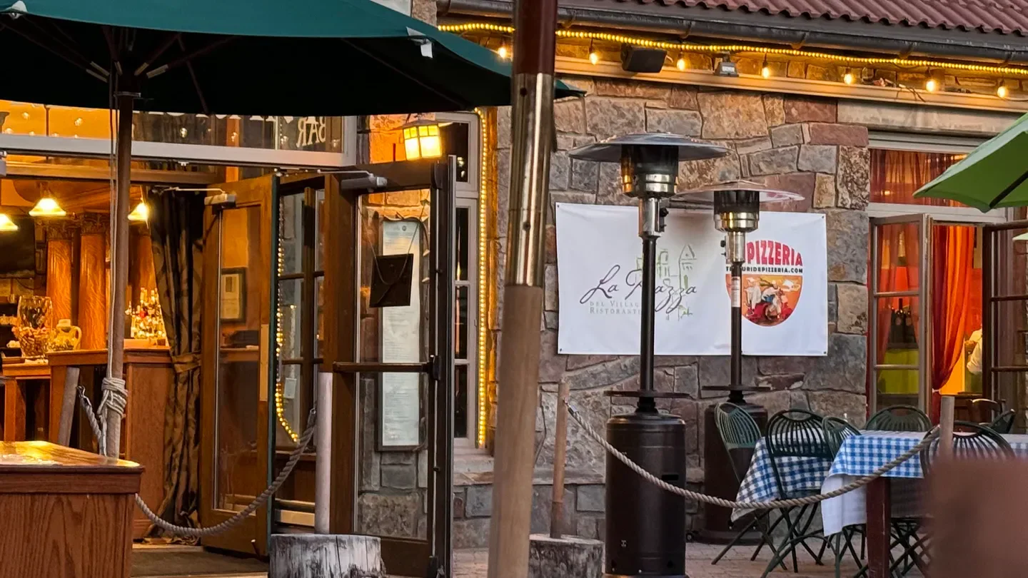 Exterior of La Piazza del Villaggio Ristorante in Telluride, featuring a cozy outdoor patio.