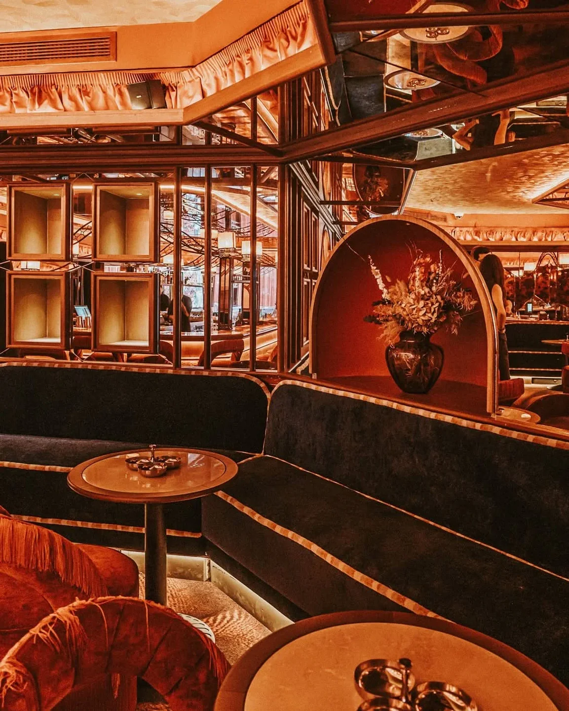 Luxurious velvet seating and ornate decor at La Plaza Puente Romano nightclub in the city.