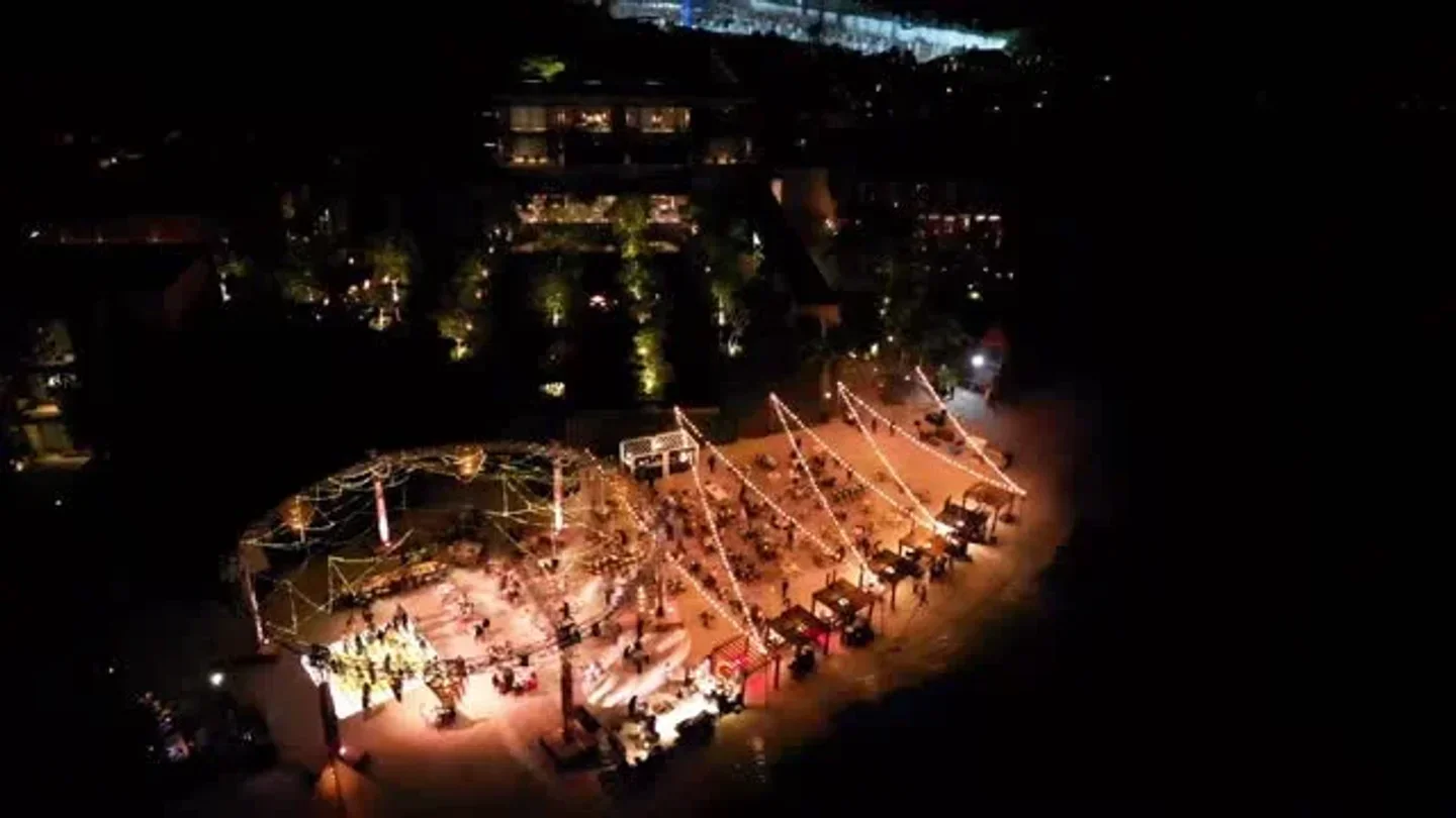 Aerial view of La Punta Grill & Lounge in Cancun at night with outdoor seating.