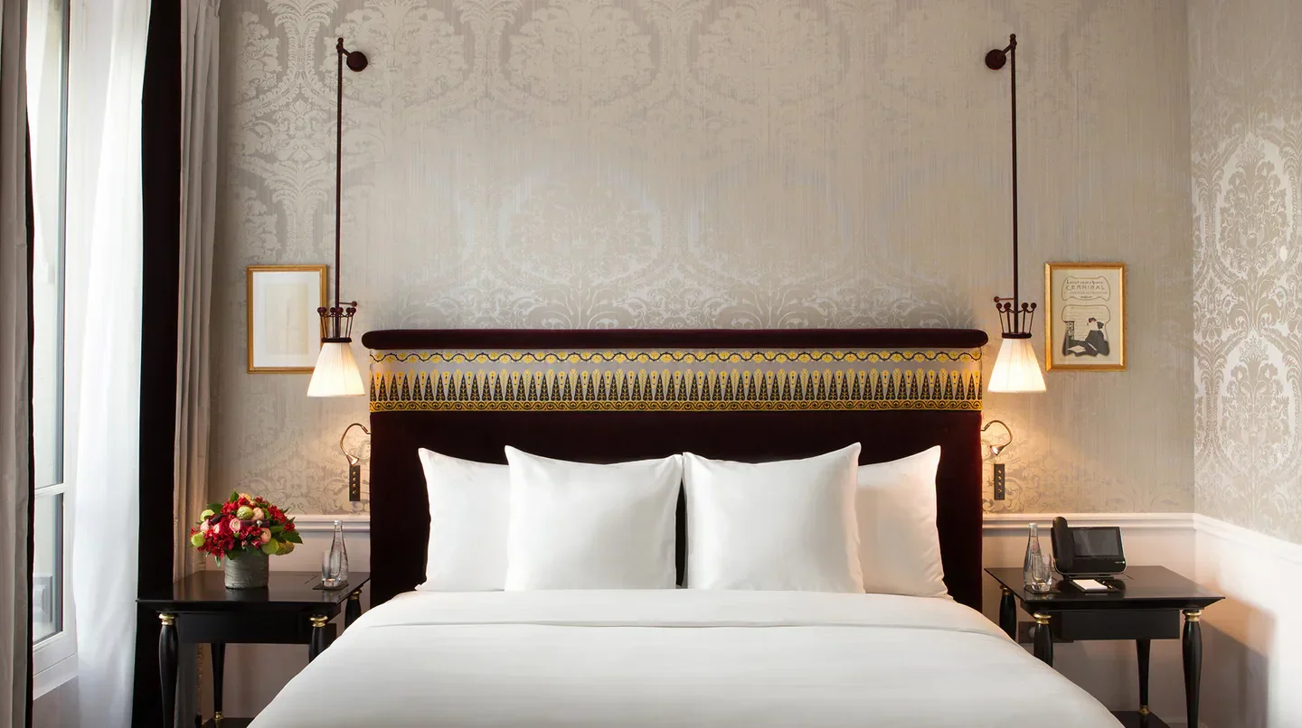 Elegant bedroom interior at La Réserve Paris hotel in Paris, featuring stylish decor.