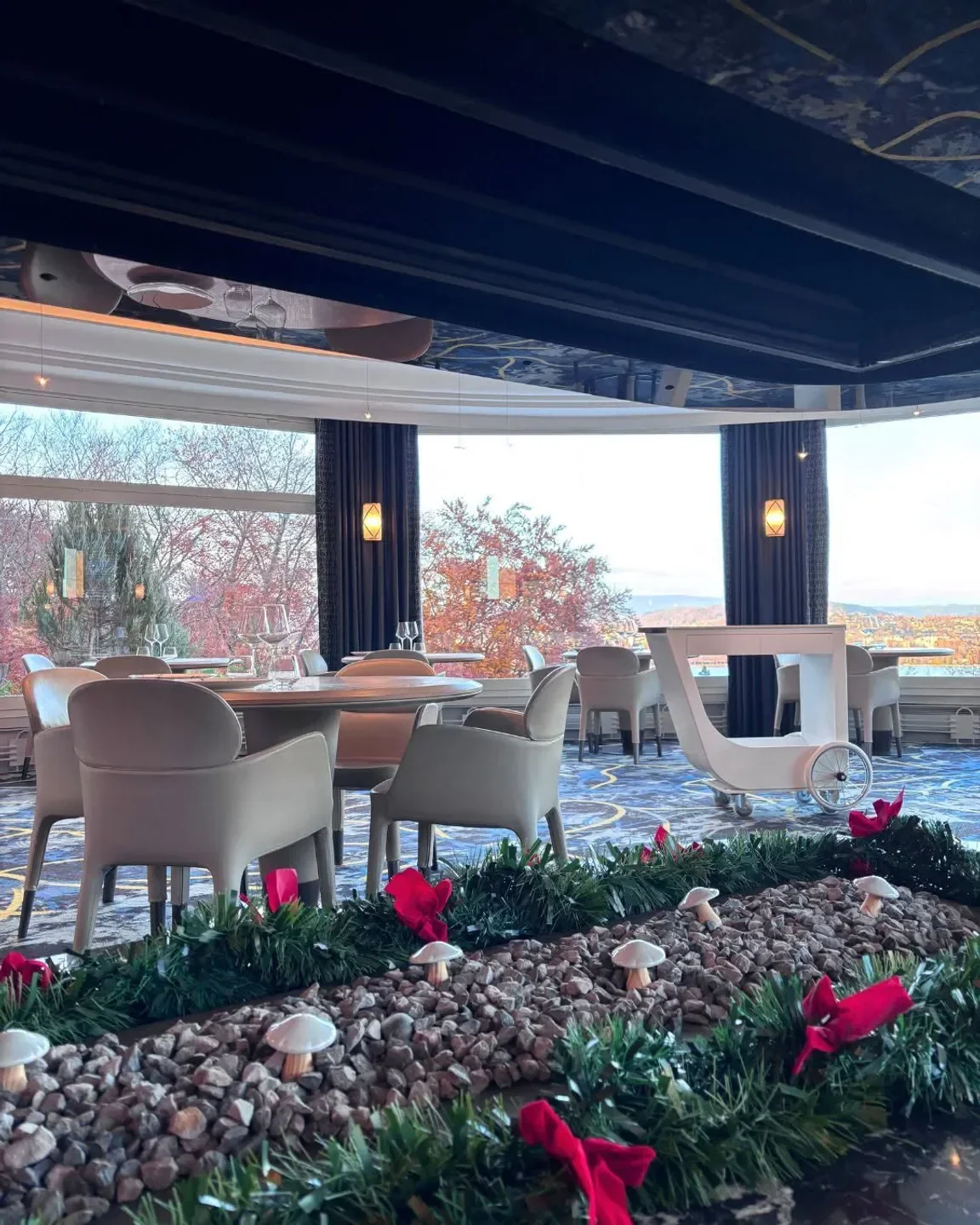 Elegant interior of La Rotonde des Trésoms restaurant in Annecy with beautiful views.