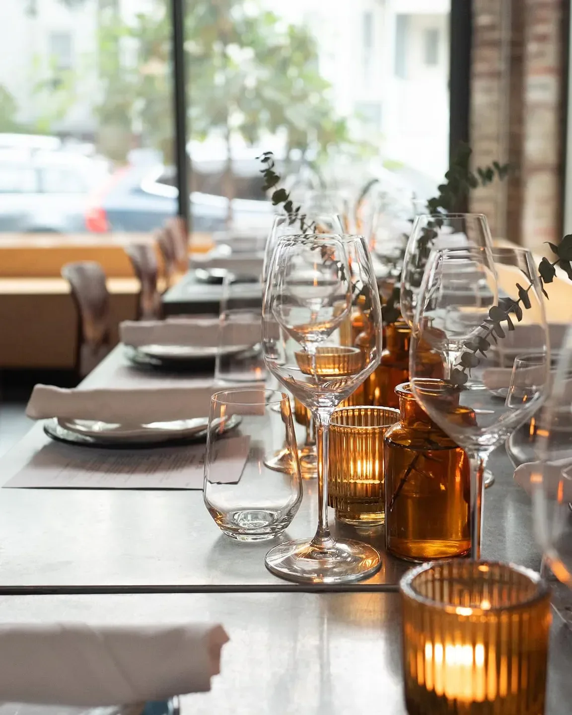 Elegant table setting at LA ROYAL restaurant in Boston, featuring glassware and candles.