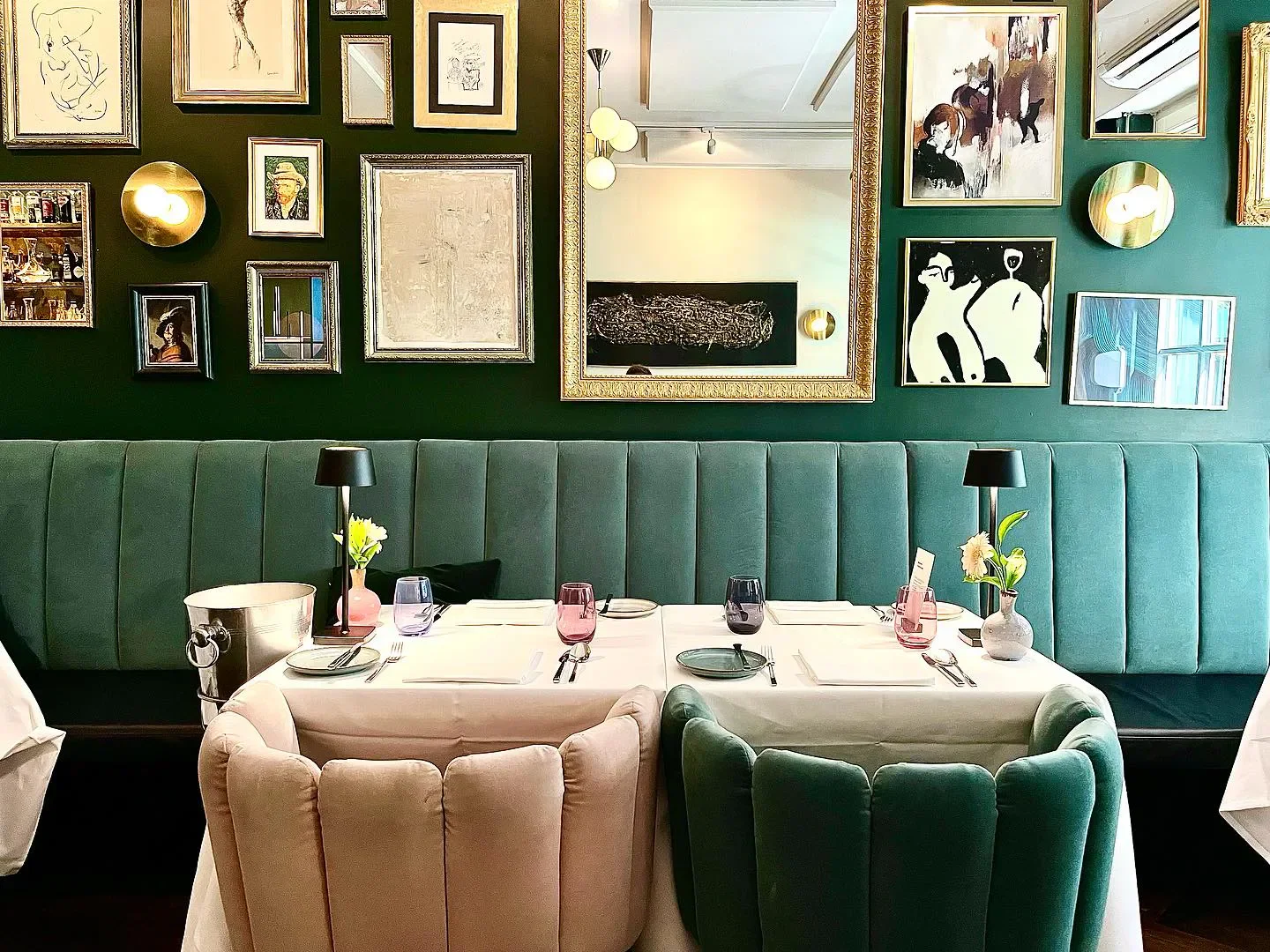 Cozy dining area at La Société Cologne, with artwork and elegant table setting.