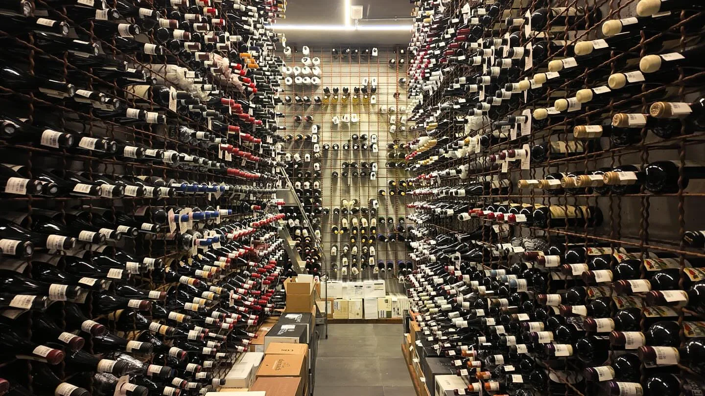 Wine cellar at La Speranzina Restaurant & Relais in Lago di Garda, Italy, with rows of wine bottles.