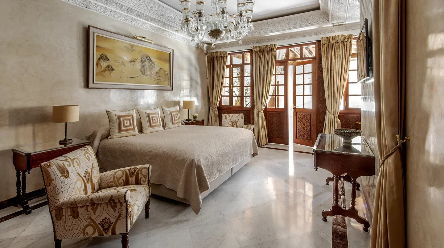 Elegant bedroom at La Sultana Marrakech hotel with ornate details in Marrakech.