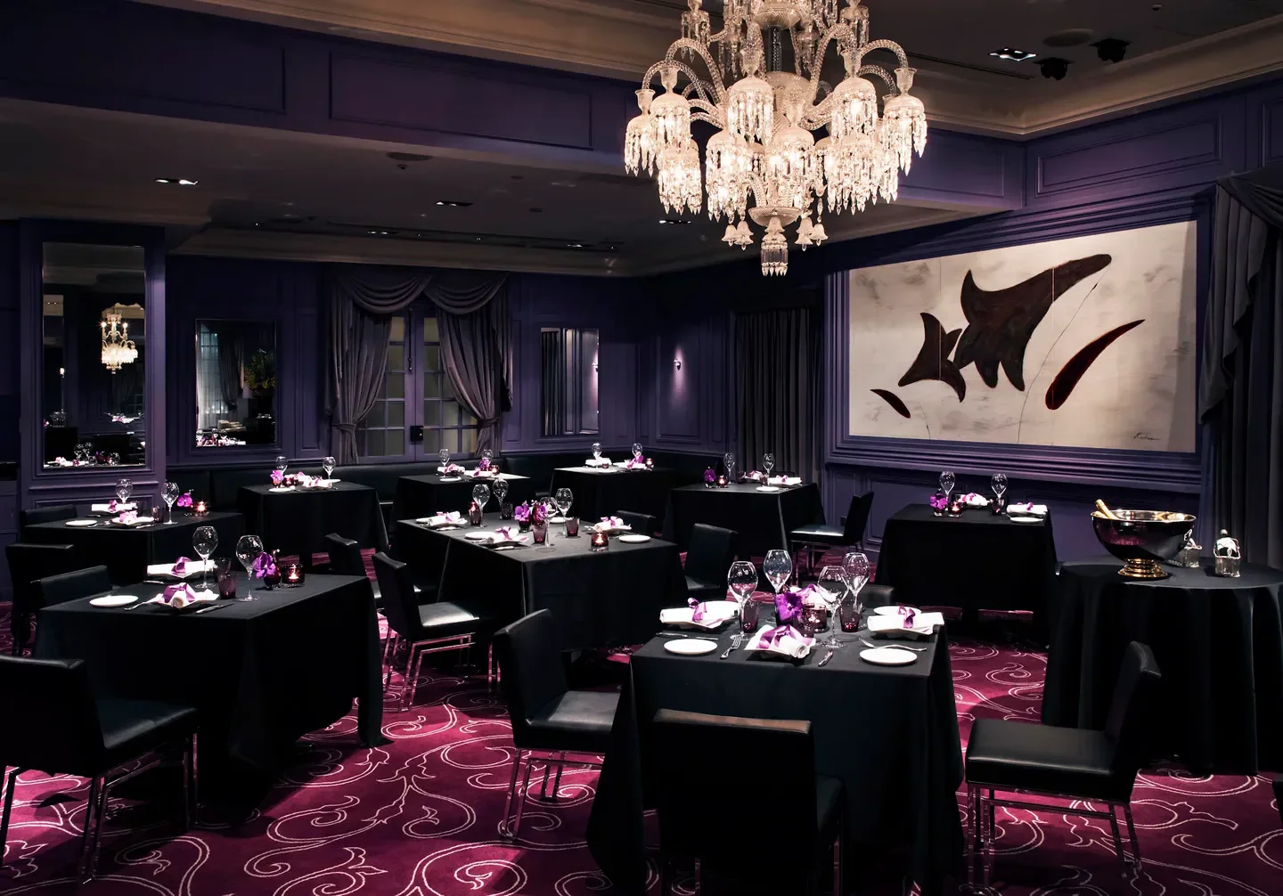 Elegant dining room at La Table de Joël Robuchon in Tokyo with chandeliers and art