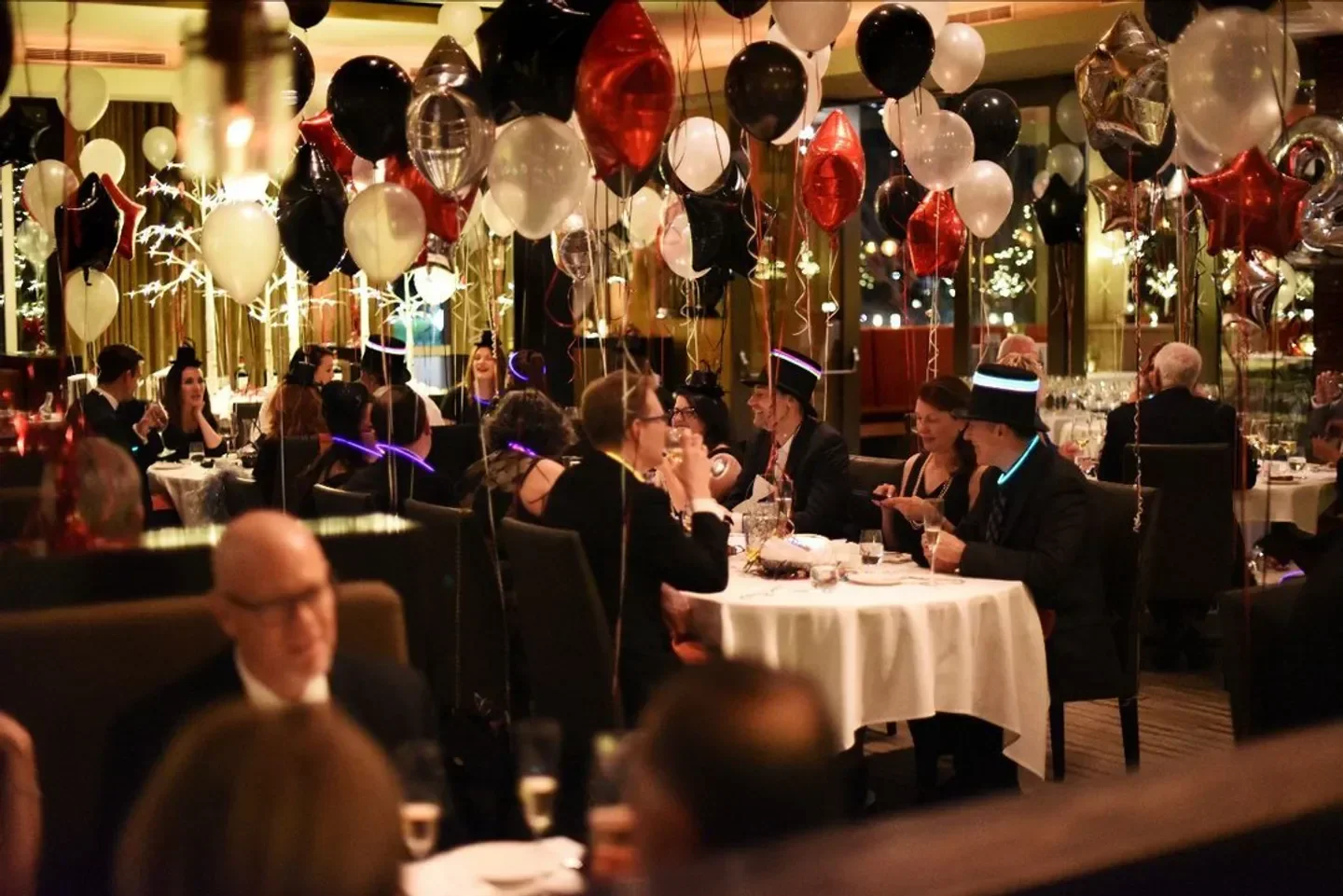 Festive dining at La Toque in Napa Valley, with celebratory balloons and joyful guests.