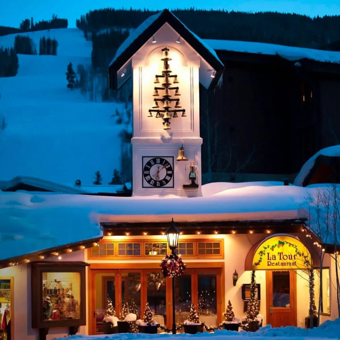 Exterior of La Tour Restaurant in Vail, featuring a clock tower and holiday lights.