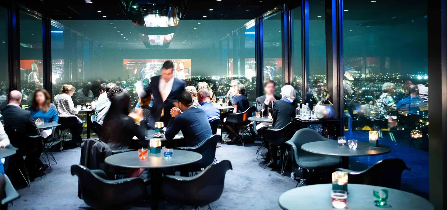 Dining at La Villa in the Sky restaurant, offering stunning city views of Brussels.
