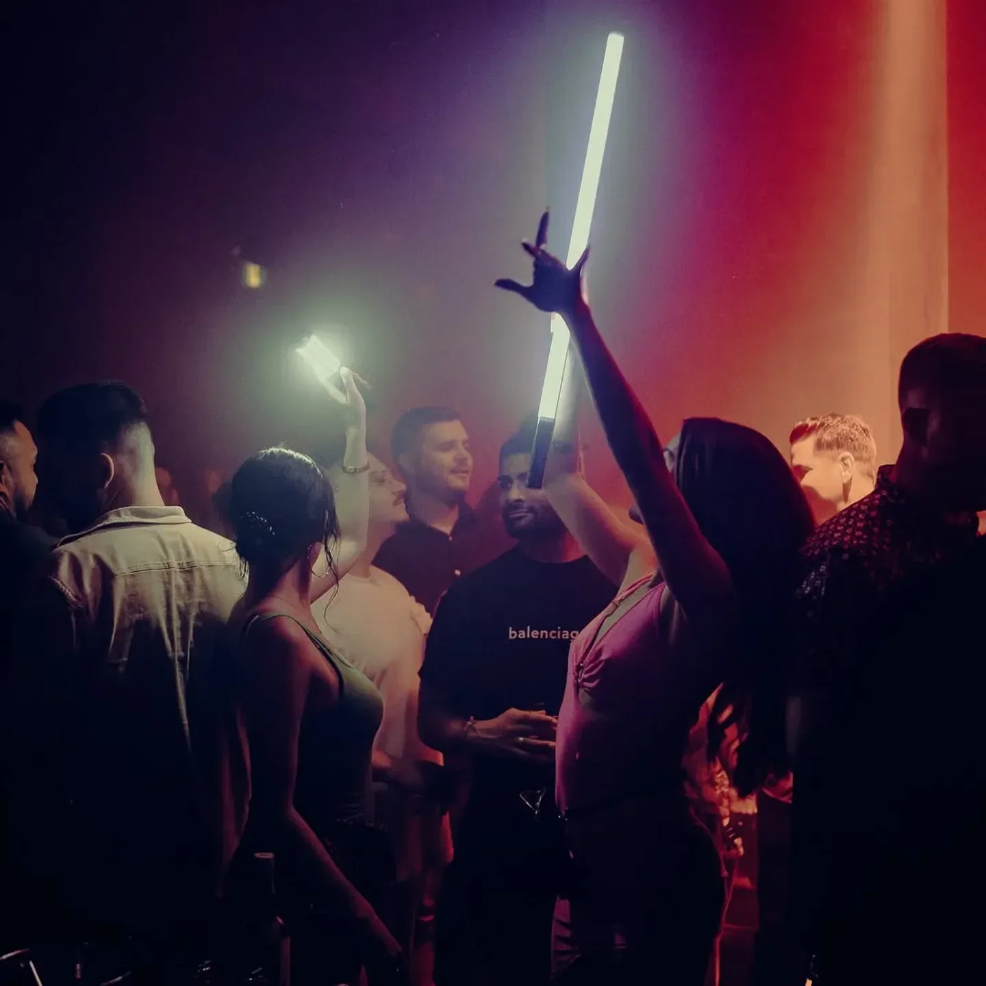Energetic crowd at La Voute nightclub in Montreal, illuminated with neon lights and a lively atmosphere.