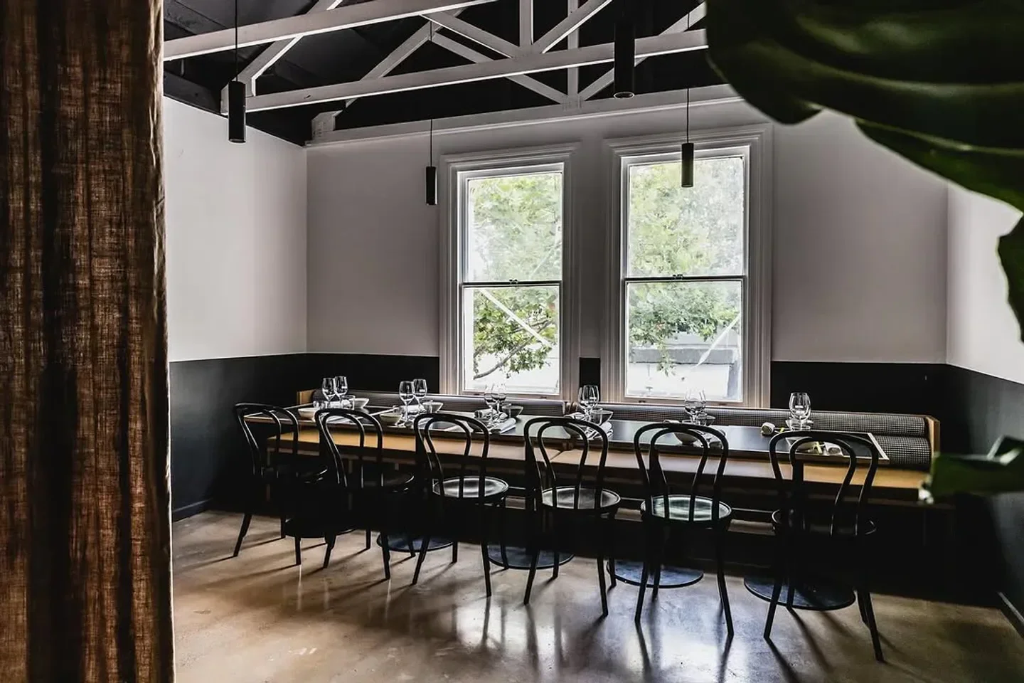 Interior of Lagoon Dining restaurant in Melbourne with dining table and windows.
