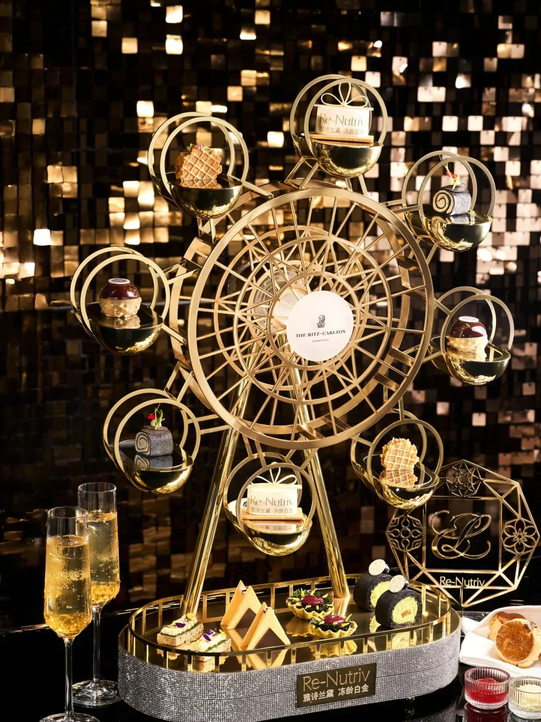 Ferris wheel of delicacies at Lai Heen in Guangzhou, with champagne flutes.