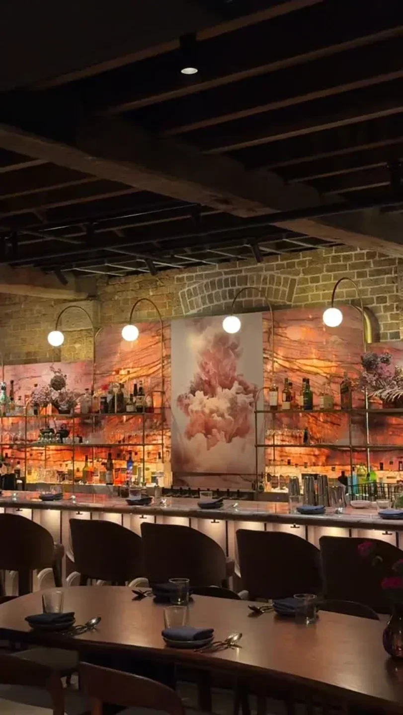 Interior of Lana restaurant in Sydney, featuring bar and dining area with artistic decor.