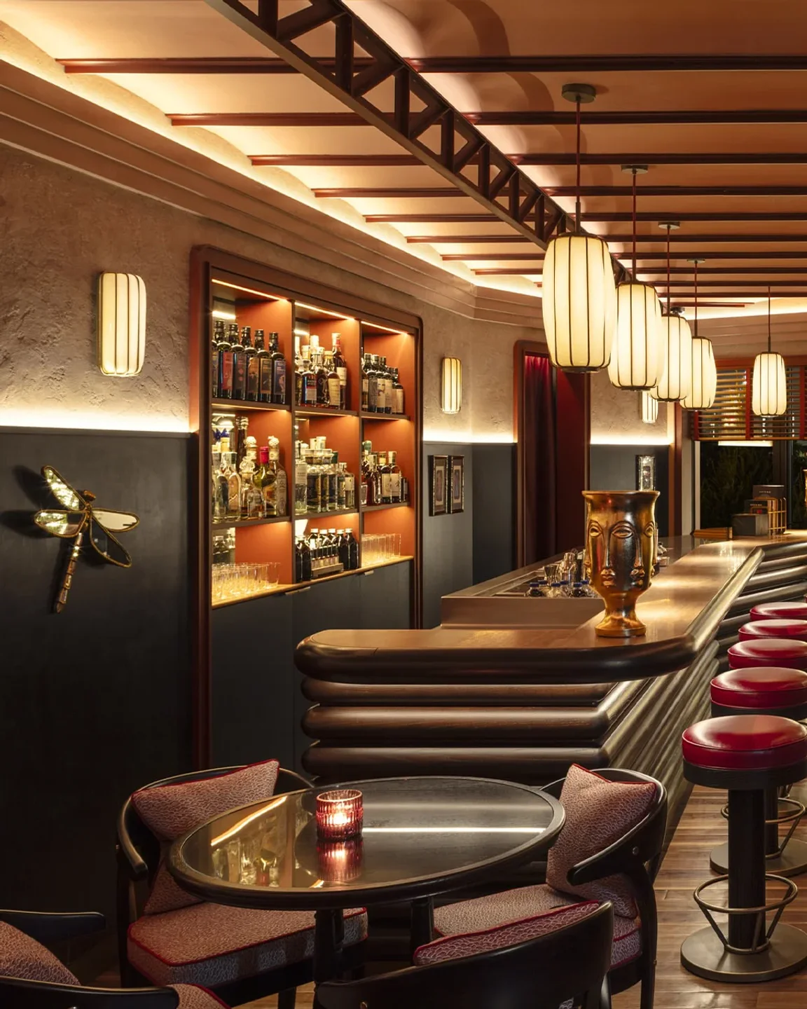 Luxurious bar interior at Langosteria Paraggi on the Italian Riviera, featuring a polished wooden bar and plush seating.