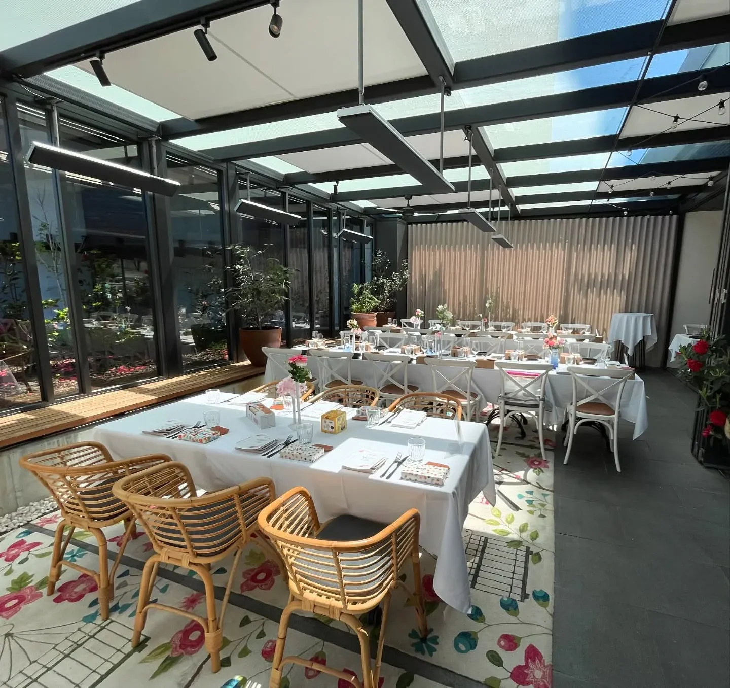 Elegant dining space at Lanterne Rooms restaurant in Canberra, with floral rug and tables set