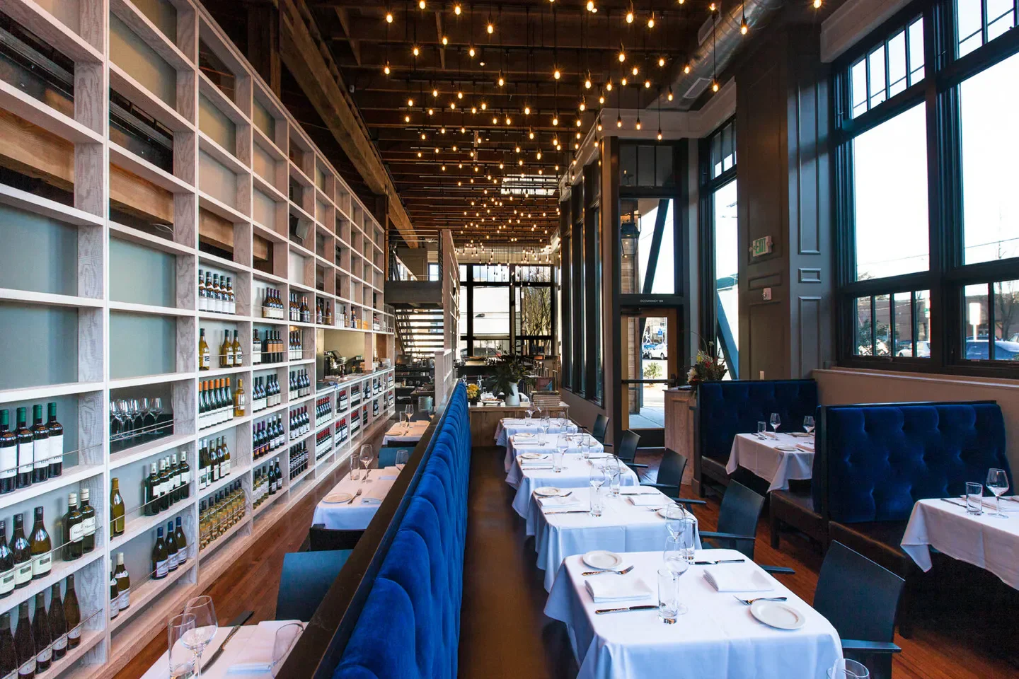 Interior of Lark Restaurant in Seattle with elegant seating and wine selection