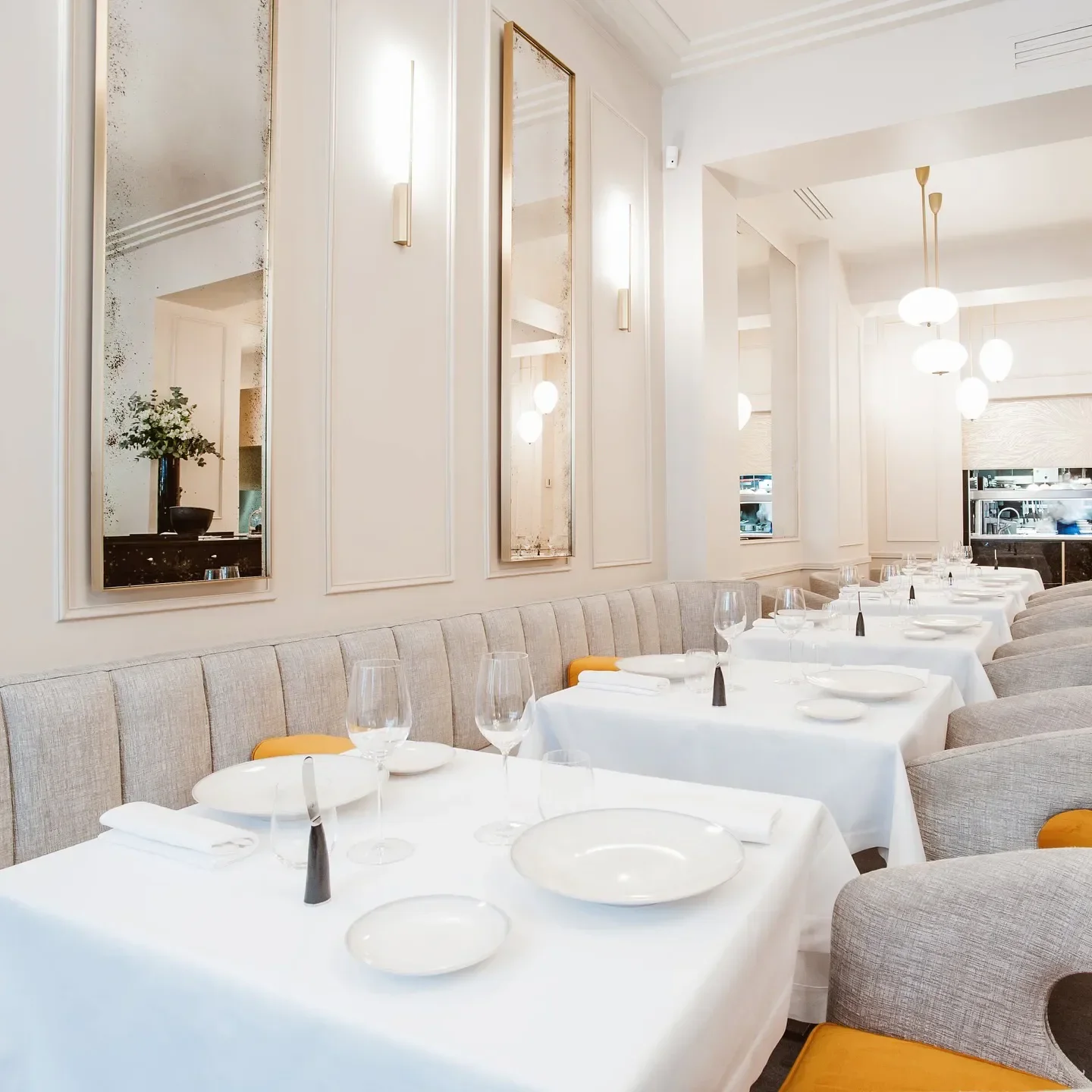 Elegant dining room interior at L'Arôme restaurant in Paris, featuring stylish decor.