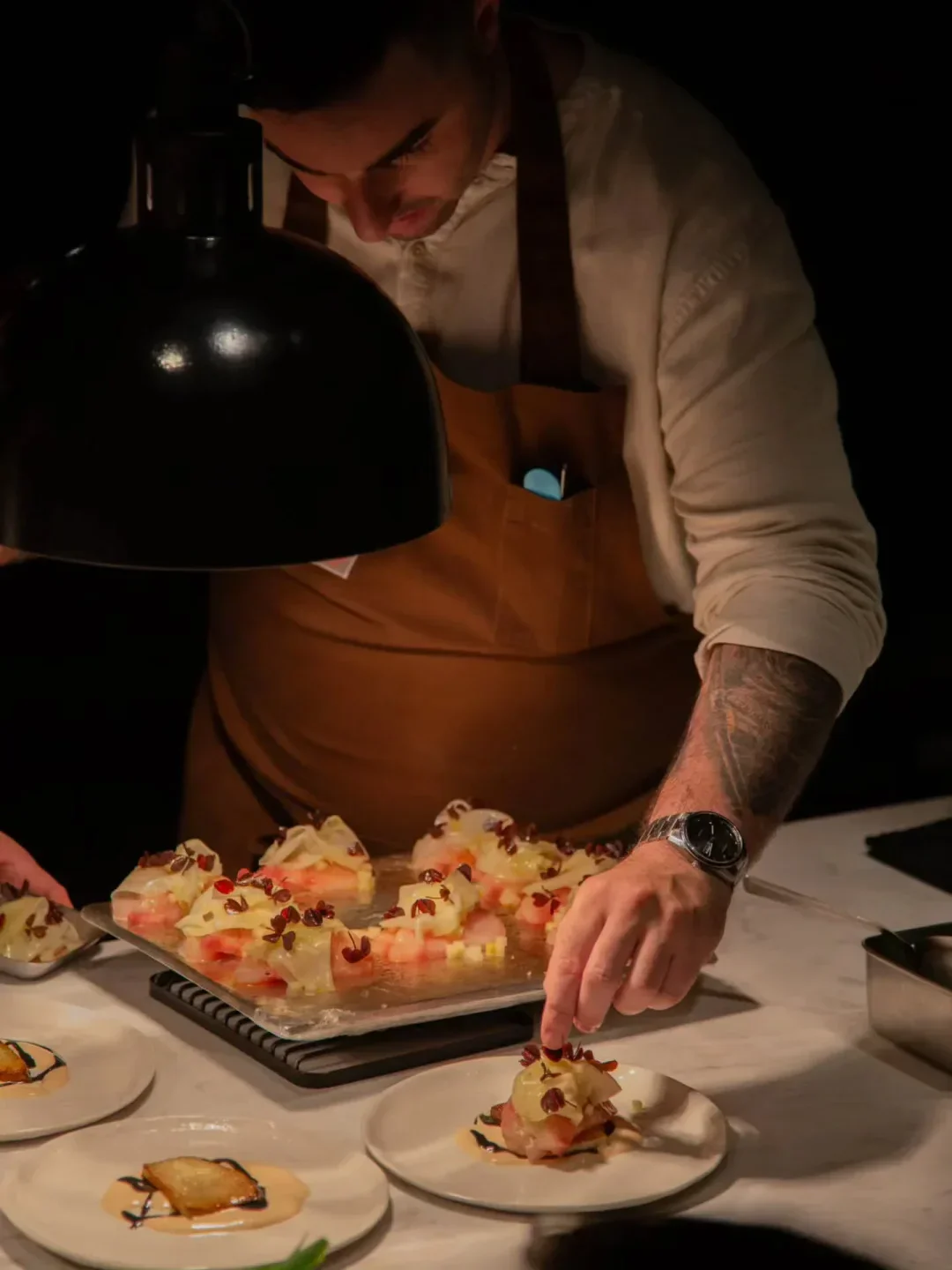 Chef plating a dish at Lasai restaurant in Rio de Janeiro, Brazil