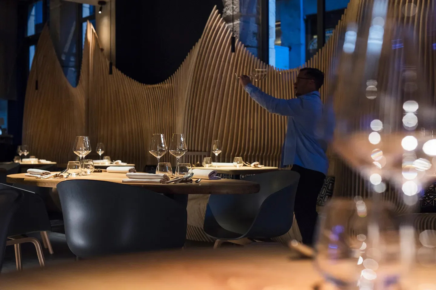 Elegant dining at L'Atelier des Augustins restaurant in Lyon, featuring stylish decor and glassware.