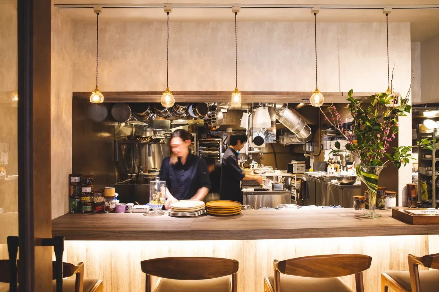 Interior view of LATURE restaurant in Tokyo, featuring chefs at work behind the counter.
