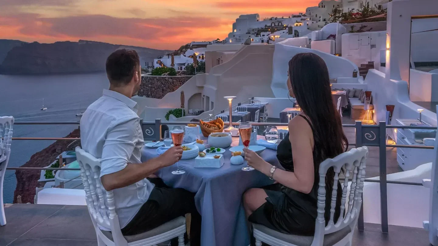 Romantic dinner at Lauda restaurant in Santorini, with sunset views and Aegean Sea.