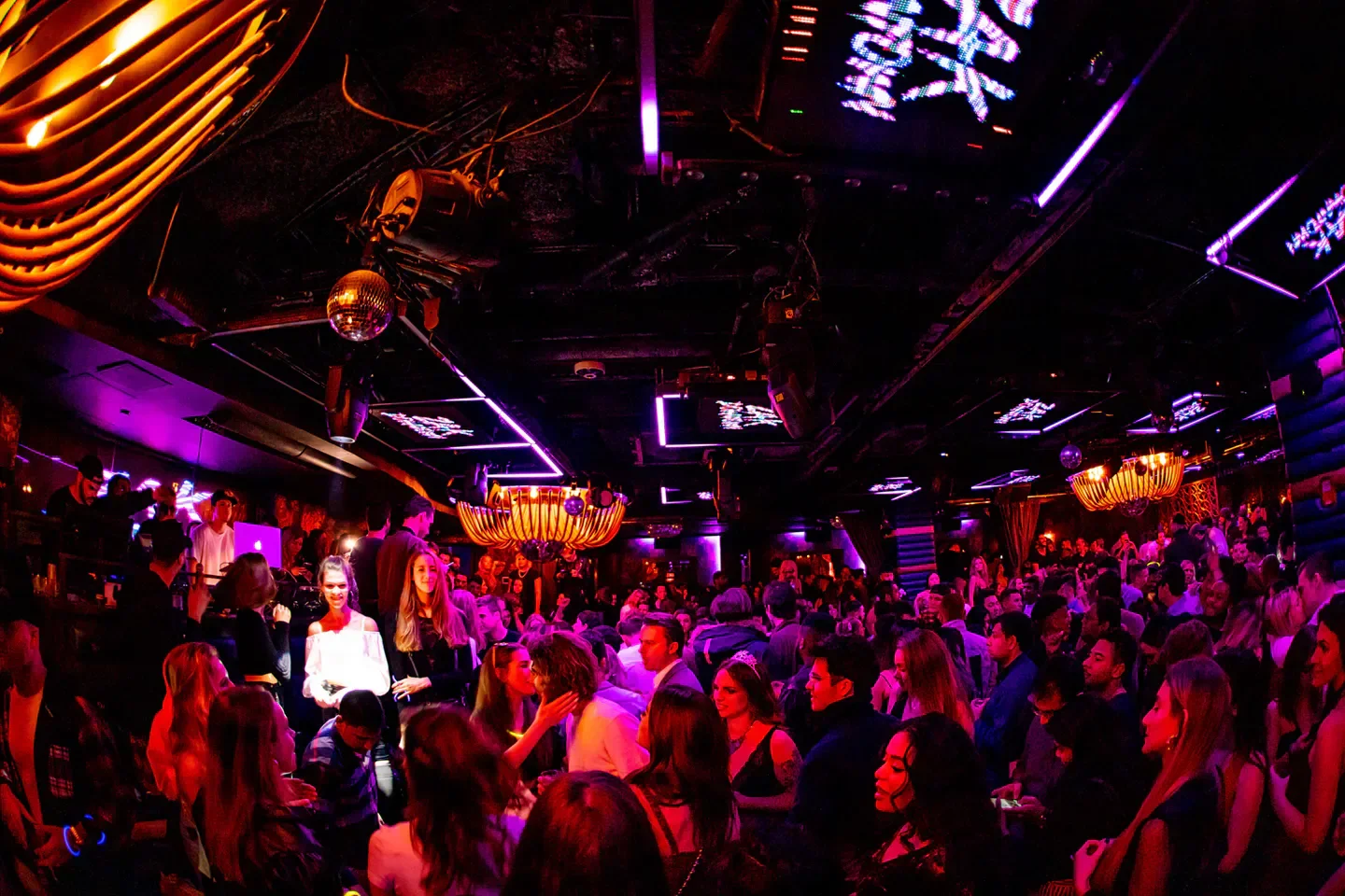 Inside Lavo New York City nightclub, crowded with partygoers dancing under lights.