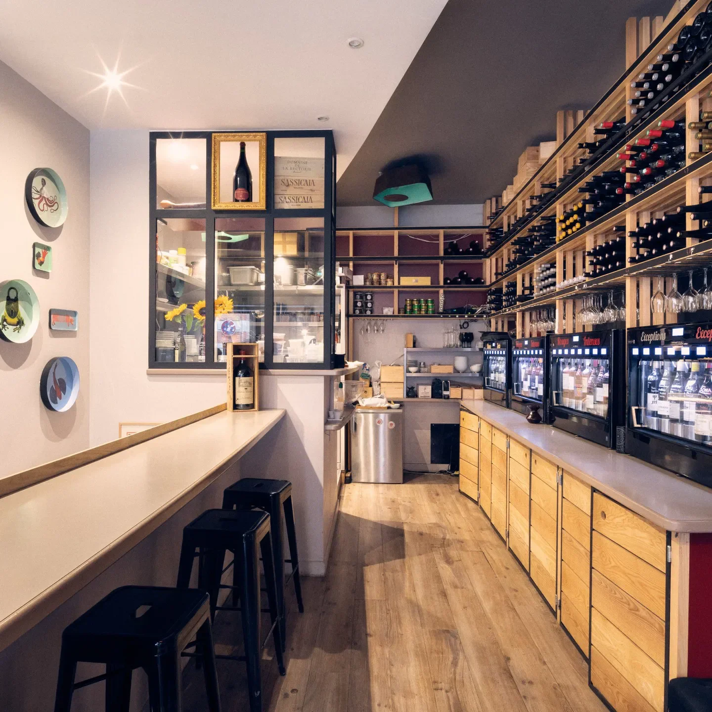 Interior view of Le 5 Wine Bar in Toulouse, showing wine racks and bar seating.