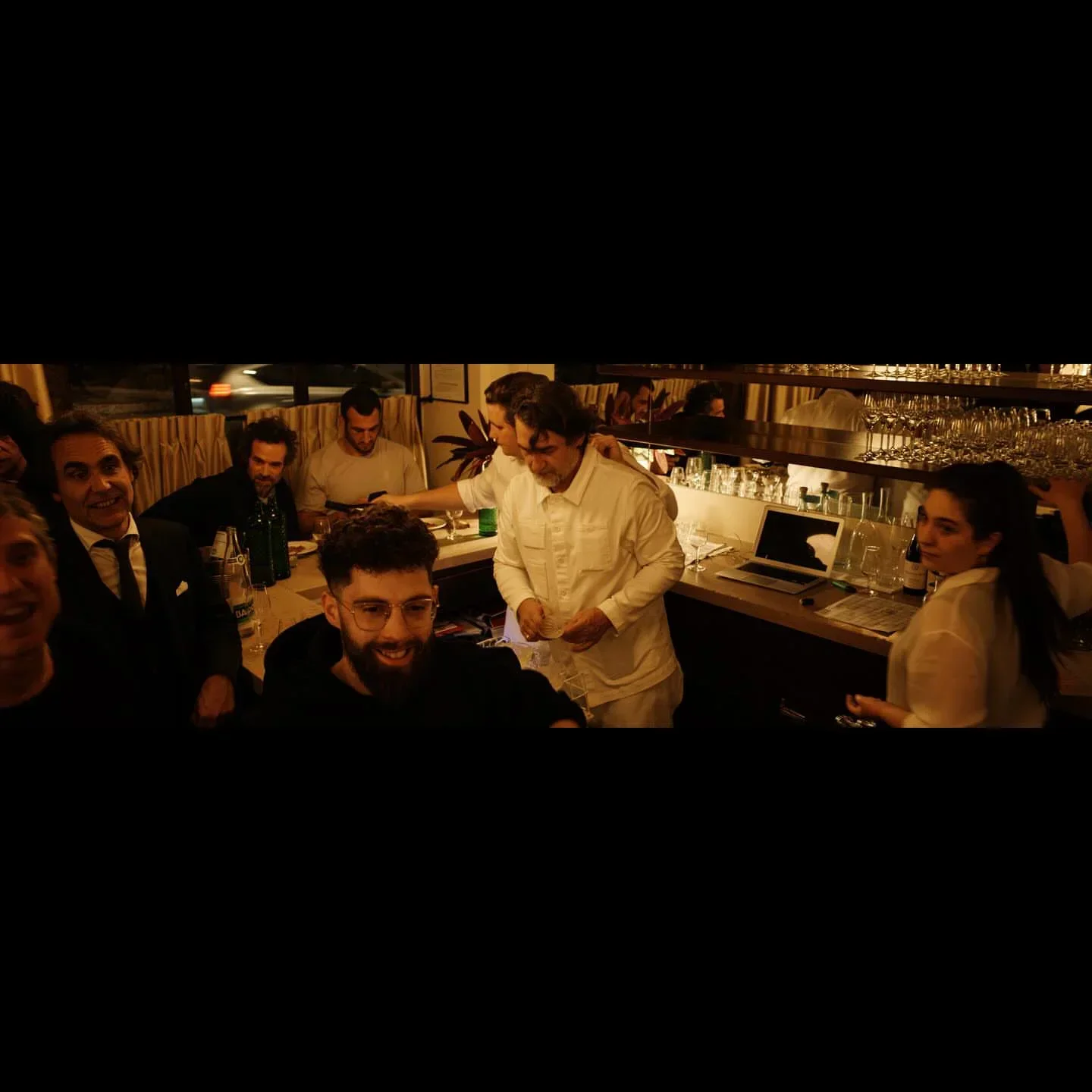 Dining at Le Chateaubriand restaurant in Paris, group of friends celebrating.