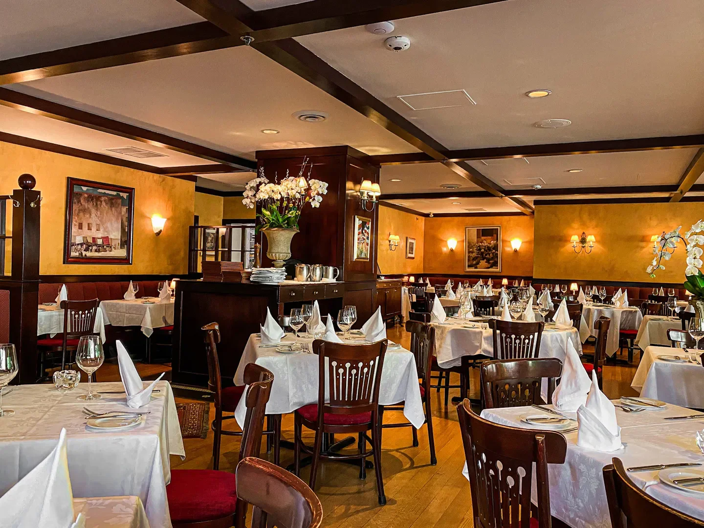 Elegant dining room interior at Le Crocodile in Vancouver, with tables set for service.