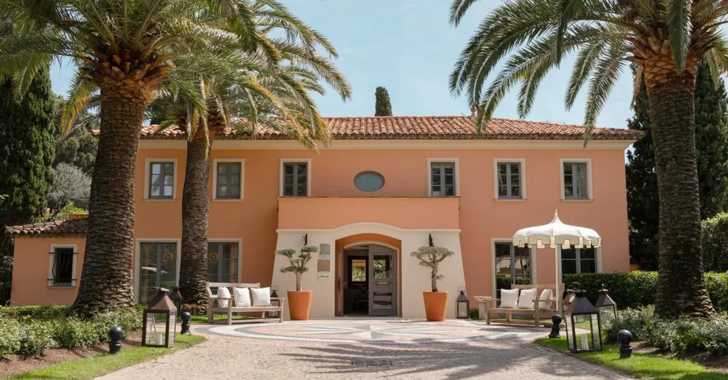 Le Jardin de la Bastide restaurant entrance in Saint Tropez with palm trees and Mediterranean architecture