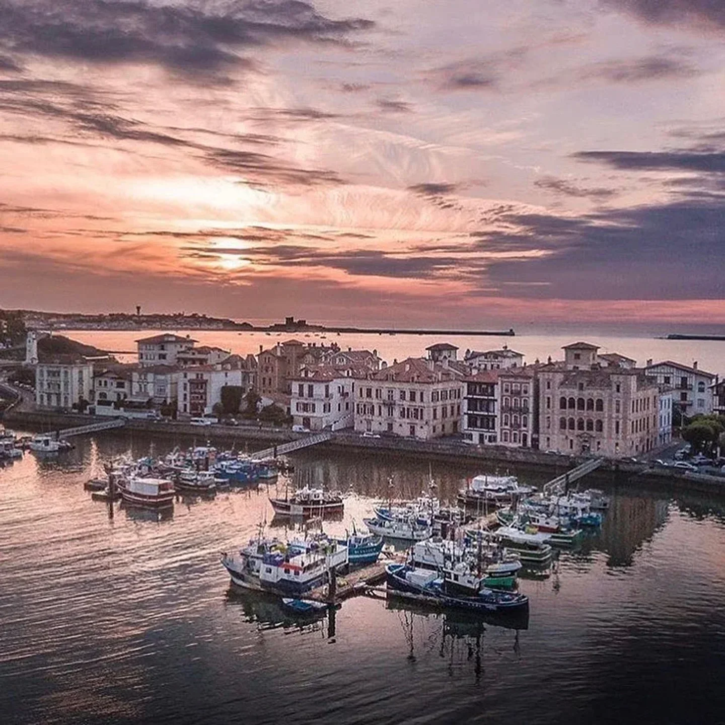 Boats docked near Le Kaïku restaurant, at sunset, French Pays Basque, beautiful scenery.